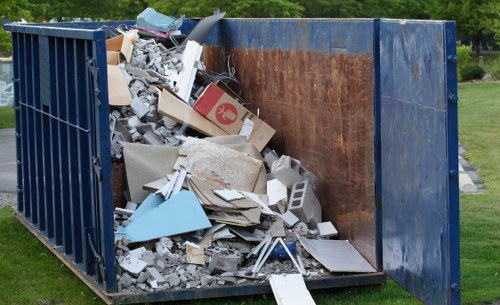 Construction site with builders waste being cleared in Highgate
